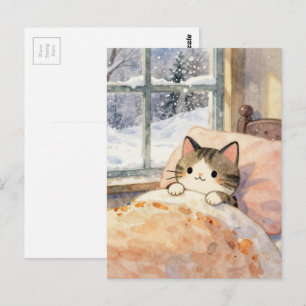 Vacker katt hålls varm i sängen på en snöig dag vykort