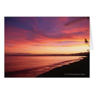 Vacker solnedgång på stranden hälsningskort