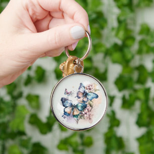Vackra fjärilar och blommor rund silverfärgad nyckelring