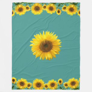Vackra gula solrosor på turkos fleecefilt