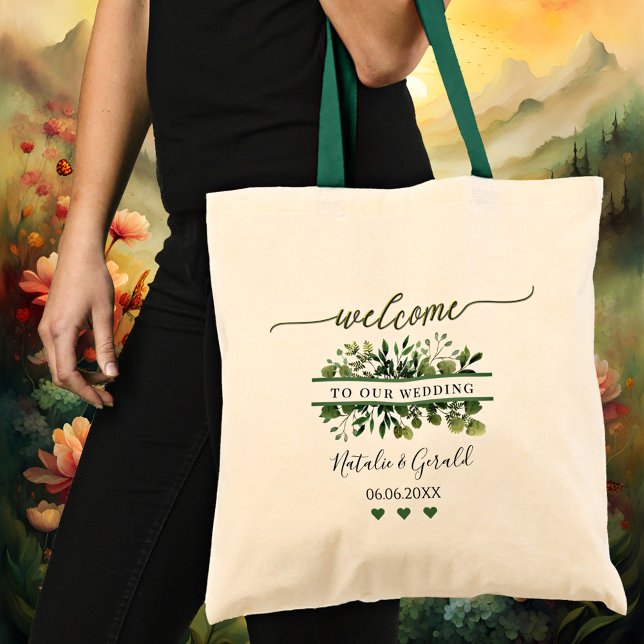 Välkomstskript Grönsaklig Bröllopstaska Tygkasse (An elegant wedding tote bag featuring a stylized green welcome script text and greenery)