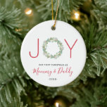 Vår första jul som Mamma och pappa Joy Wandan Julgransprydnad Keramik<br><div class="desc">Elegant helgdag med ornament med "JOY" med brev "J" och "Y" i ett rött sans serif-teckensnitt och en vattenfärg som målas i grönsaksmandningen som "O" i brev. "Vår första jul som Mamma och pappa" tillsammans med året. Den här söta prydnaden är en perfekt gåva till nya föräldrar eller till behålla...</div>