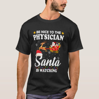 Var snäll mot läkarens tomte som tittar på Julafto T Shirt