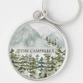 Vattenfärg i skogen och bergsmiljön rund silverfärgad nyckelring