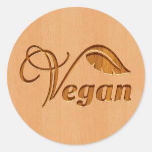 Vegan-logotyp som bärs i träeffekt runt klistermärke