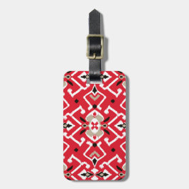 Vibrant ikat mönster i rött, vitt och svart bagagebricka