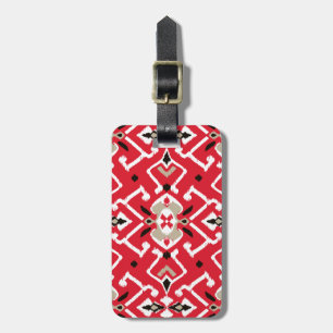 Vibrant ikat mönster i rött, vitt och svart bagagebricka