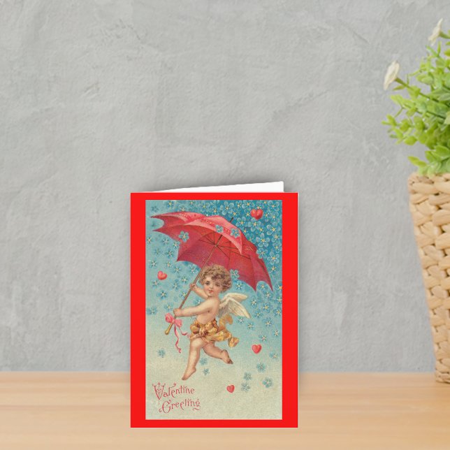 Victorian Valentine Cupid Hearts Umbrella Helgkort (Victorian flying cupid red umbrella harts snowflakes on red Valentine's greeting card.)