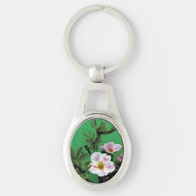 vild rosa ros blommor i grönt. ovalt silverfärgad nyckelring (Framsidan)