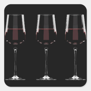 Vin-glas med rött vin på svart fyrkantigt klistermärke