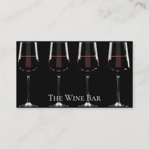 Vin-glas med rött vin på svart visitkort