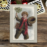 Vintage Boy i Snö med God jul Hälsning Julkort<br><div class="desc">Skolpojke i vintage som har ett kallt köl och som går genom snö och tippar hatten och viftar med en massa mistletoe med God jul hälsning.</div>