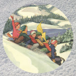 Vintage jul, barn som leker på ett berg runt klistermärke<br><div class="desc">Vintage illustration av God jul helgdag snöslingor med barn,  en grupp pojkar och flickor med roligt som sjunker ner i en backe täckt av snö. Bergen,  träd och sjö kompletterar detta vackra vinterlandskap. Påminner mig om vintrarna i Donner i Sjö Tahoe.</div>