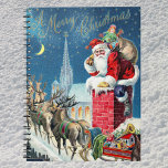Vintage jul Victorian Jultomten på Skorsten Anteckningsbok<br><div class="desc">Vintage illustrerar julens helgdag med ett Victorianskt Jultomten på en tak som ska gå ner i skorsten. Renarna och sömnen står på tak och väntar. En vacker kyrka ligger i bakgrunden med stjärnor och måne i den blå natten himlar.</div>