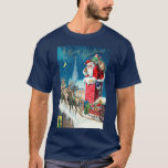 Vintage jul Victorian Jultomten på Skorsten T Shirt<br><div class="desc">Vintage illustrerar julens helgdag med ett Victorianskt Jultomten på en tak som ska gå ner i skorsten. Renarna och sömnen står på tak och väntar. En vacker kyrka ligger i bakgrunden med stjärnor och måne i den blå natten himlar.</div>