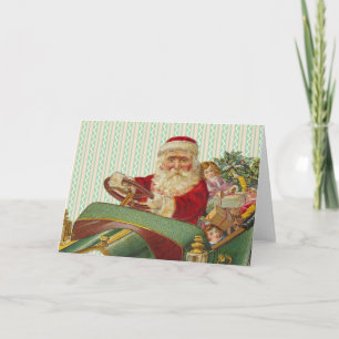 Vintage-jultomten i en klassisk antikisk bil helgkort