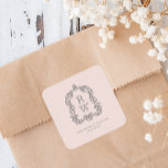 Vintage Monogram Crest Names Blush Pink Wedding Fyrkantigt Klistermärke<br><div class="desc">This elegant design features an ornate,  regency vintage-inspired crest of acanthus leaves framing two monogram initials in open serif font,  stacked vertically and separated by a thin horizontal line. Add the couple's names and wedding date below. The design and text are in charcoal gray on a blush pink background.</div>