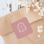 Vintage Monogram Crest Names Dusty Rose Wedding Fyrkantigt Klistermärke<br><div class="desc">This elegant design features an ornate,  regency vintage-inspired crest of acanthus leaves framing two monogram initials in open serif font,  stacked vertically and separated by a thin horizontal line. Add the couple's names and wedding date below. The design and text are in white on a dusty rose background.</div>