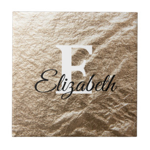 Vintage Monogramtypografi guld har fallit samman p Kakelplatta