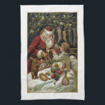 Vintage Pappa jul Ge gåvor till barn Kökshandduk<br><div class="desc">Elegant och tidlös traditionell julkonst med leende ge julklappar till ett barn i sängen med boskap hängande i närheten och mistletokonst. Konsten förskönas med guld högdagrar och färg i bakgrunden är redigerbart.</div>