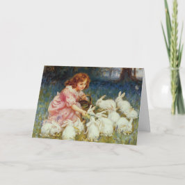 Vintage påskflicka som matar vita kaniner helgkort