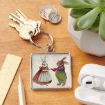 Vintage Rabbit Couple i Viktorian Clothing Fyrkantig Silverfärgad Nyckelring<br><div class="desc">Vi presenterar ett charmerande och vismiskt tillägg till dina tillbehör - Vintagen Rabbit Couple i Viktorian Clothing keychain. Den här fina designen har ett par reflexinspirerade kaniner som är klädda till ninerna i vismisk Victoriasättning och som tillför lite charm med vintage till dina vardagsbehov. Perfekt för djur älskare och vintage...</div>