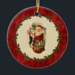 Vintage Santa and Stockings Ornament<br><div class="desc">Vackra och nostalgiska bilder av tomten vid en för länge sedan het fyllning med julslitningar. Han gränsar till ett band av guld-sintingad holly och rik röd botten. Bilden har återställts digitalt.</div>