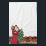 Vintage Santa och Träd Kökshandduk<br><div class="desc">Den nostalgiska viktorianska tomten som håller ett träd och bär med sig en väska av leksak på en genomskinlig bakgrund med en välsköljd rödtrim och guld-trim med God jul hälsning.</div>