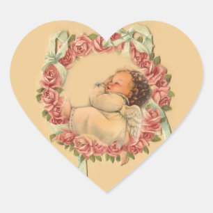 Vintagebabyängel som sovar på en rosenkrans hjärtformat klistermärke