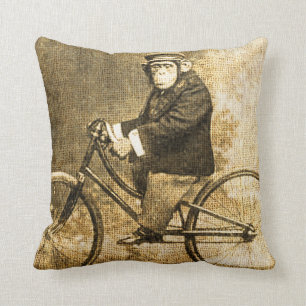 Vintageschimpans på en cykel kudde