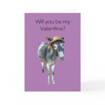 Violet åsnan i sugrörhatt med blommor