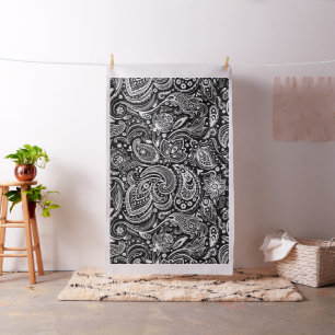 Vit blommigt paisley mönster på svart tyg