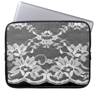 Vit blommigt snöre mot svart bakgrund. laptop fodral