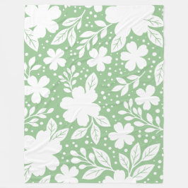 Vit blomsterdesign på mjuk grön bakgrund fleecefilt