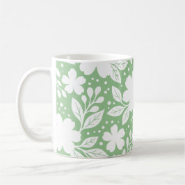 Vit blomsterdesign på mjuk grön bakgrund kaffemugg