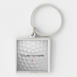 Vit golfboll med gropig textur och anpassat namn o fyrkantig silverfärgad nyckelring