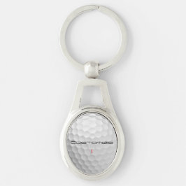 Vit golfboll med gropig textur och anpassat namn o ovalt silverfärgad nyckelring