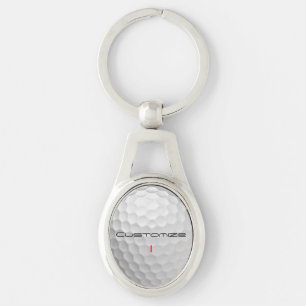 Vit golfboll med gropig textur och anpassat namn o ovalt silverfärgad nyckelring