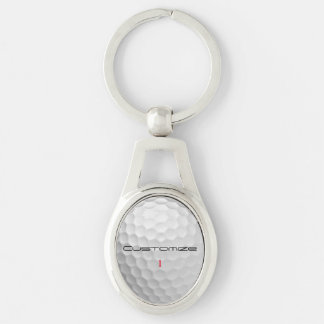 Vit golfboll med gropig textur och anpassat namn o ovalt silverfärgad nyckelring