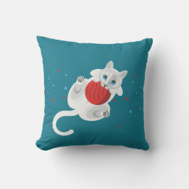 vit katt som leker med röd boll och blad kudde