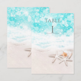 Vit sandstrand sjöstjärna blå hav bord nummer inbjudningar
