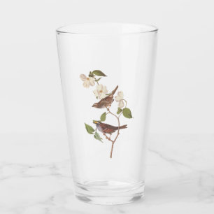 Vita halmstrå ungfåglar med rött ljus med blommor glaskopp