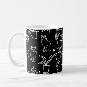 Vita katter i svart kaffemugg
