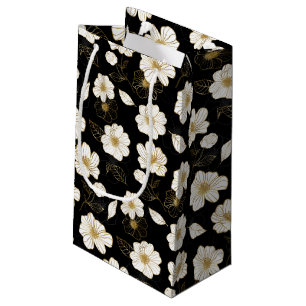 Vita och gyllene blommor på svart