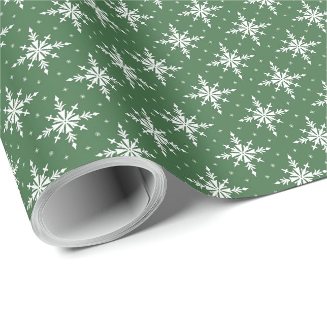 Vita snöflingor på grönt presentpapper för högtide (Rullad Hörn)