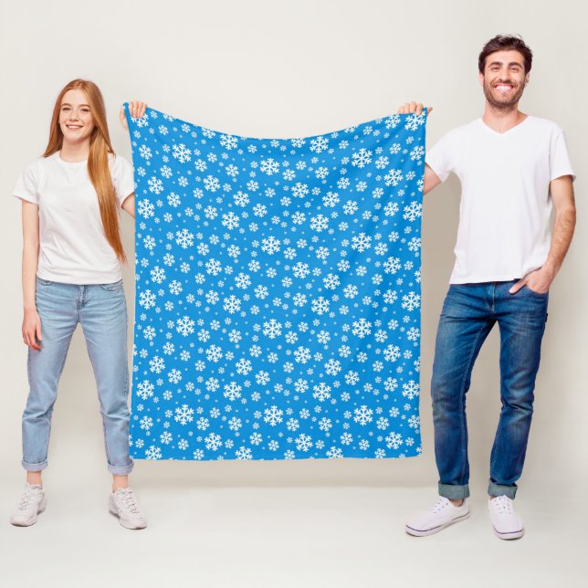 Vita snöflingor på mellanblå vinterbakgrundsmönste fleecefilt (På plats)