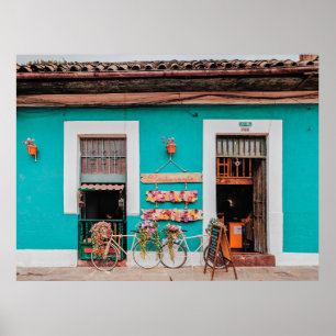 VITBICYCLE PARKED BESIDE TEAL PAINTED CONRETE POSTER