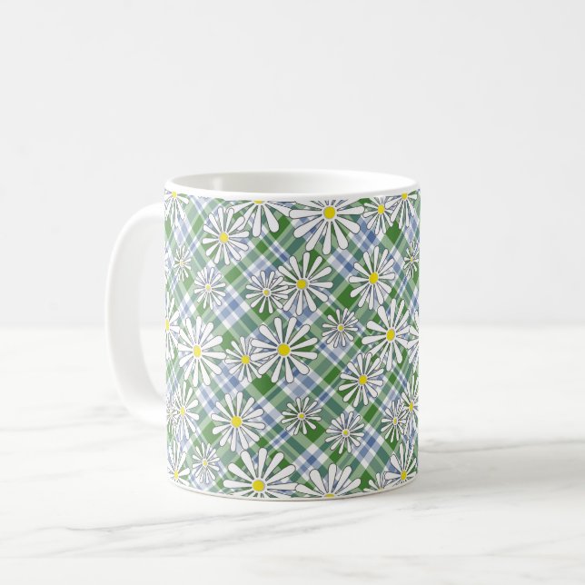 Vitkamomill blommor på en grönt blå, kontrollerad kaffemugg (Framsida vänster)