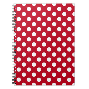 Vitt polka dots på rött anteckningsbok med spiral