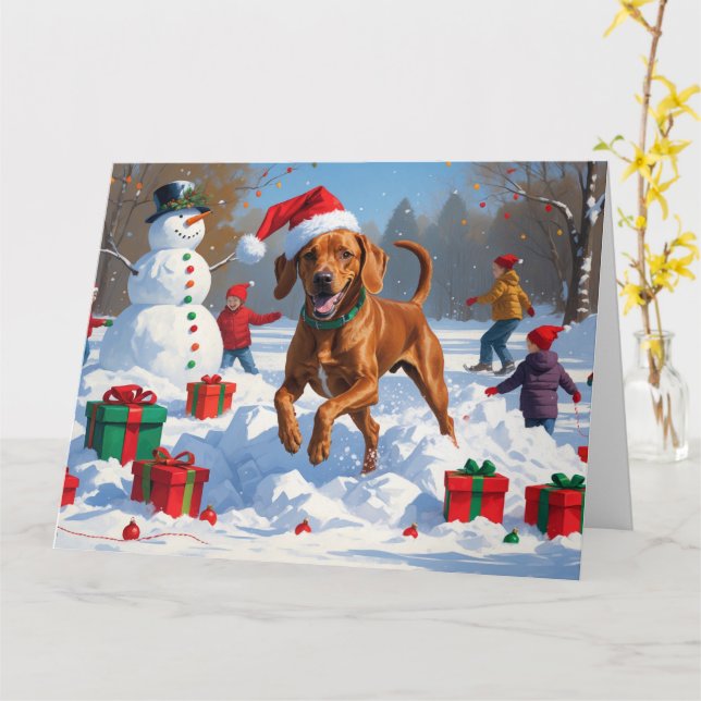 Vizsla springer i snö med julhatt kort (Gul blomma)